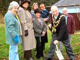 The Mayor Councillor Peter Evans plants a tree