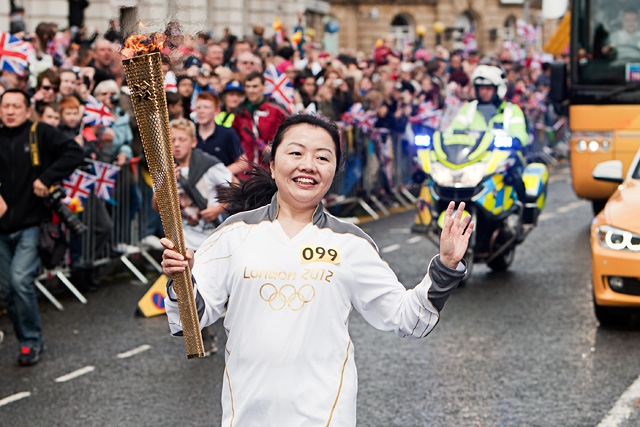 Wensheng Li aarives in Rochdale Town Centre with the Olympic Torch
