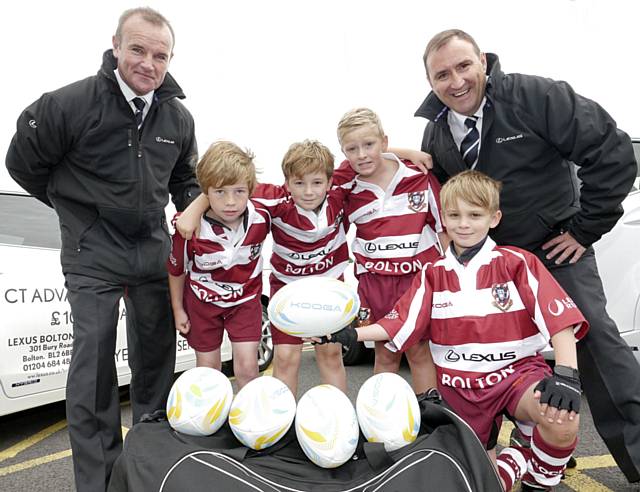 Rochdale Rugby Union Football Juniors team with their new kit with RRG Lexus sales team employees Kevin Riley (L) and Andrew Young (R)