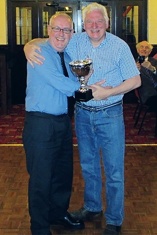 Ian Smith from the Rotary Club of Rochdale East receives the trophy from the President of host club Heywood Rotary Club, Edwin Partridge
