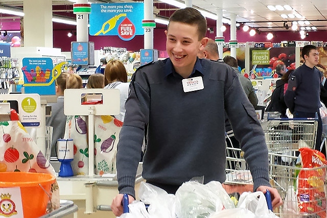 Air Corps squadron member bag packing in Tesco Rochdale