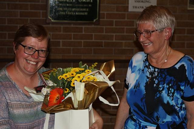 RBH Customer Involvement Officer Helen Kelsall receives a basket of flowers from resident Shirley McHugh