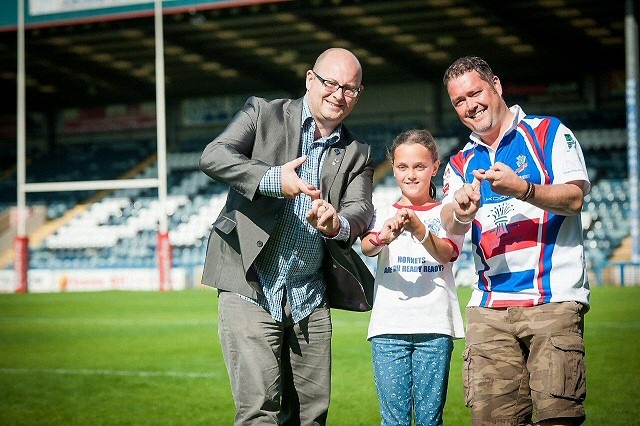 Hornets Director Martin Ballard with Mark Harris and Joining Jack Fundraiser, Millie Harris giving the 'Joining Jack' salute