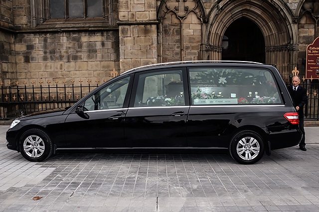 Jim Dobbin's coffin arrives at at Salford Cathedral