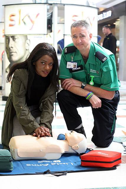 Antoinette Mupeta getting some liffe saving tips from Laurence Brennand of St John Ambulance