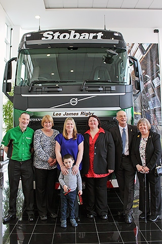 Phil McClure, Julie McClure, Rebecca Rigby, Jack Rigby, Carole Groves (Help for- Heroes Regional Manager), Raymond McClure and Diane McClure with the Stobart Truck named Lee James Rigby