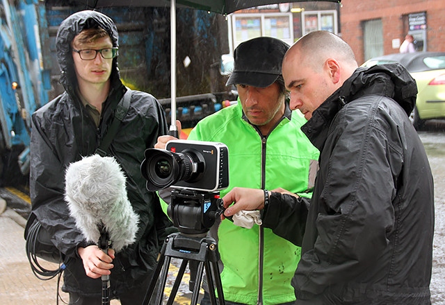 John Farrington (centre) filming in Rochdale