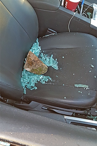 Brick thrown through the window of the taxi