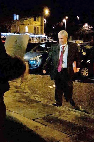 Council Leader Richard Farnell avoids protesters by using the back door at Rochdale Town Hall