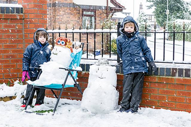 Noah and Isaac Journeaux with their snowmen
