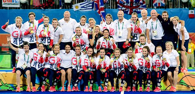 Great Britains Hockey staff and players on the podium with their gold medals