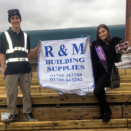 Courtney (right) with her sponsors R&M Building Supplies