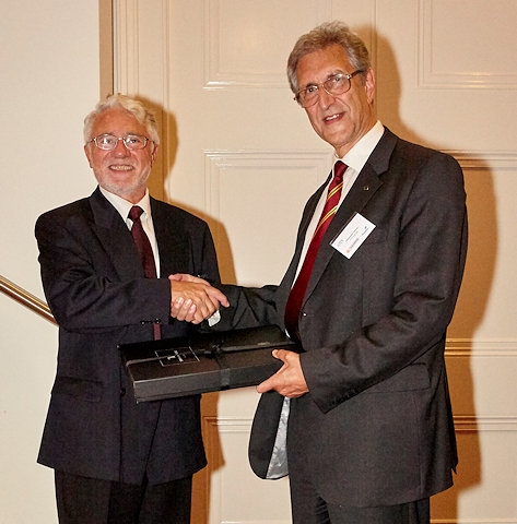 Professor Nikola Stosic (left) recognises the considerable contributions made by Dr. Christopher Holmes (right), to the International Conference on Compressors and their Systems