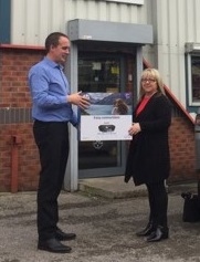 Limes manager Collette Heaton receiving a printer from James Waldron