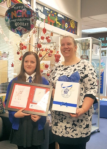 Beverley Heyworth presents Ruby Spencer with her prize for winning the 2017 “Design A Christmas Card” competition