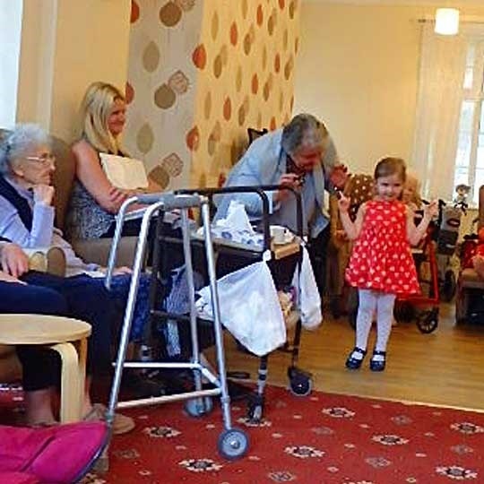 Children sing incy wincy spider for residents at Half Acre House 
