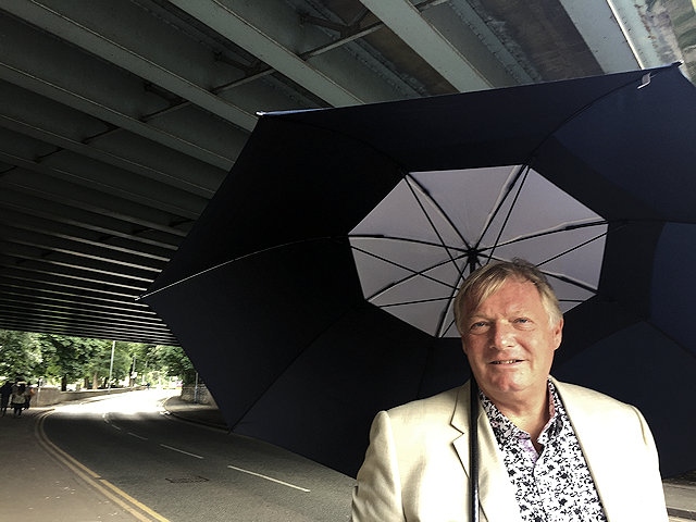 Councillor Neil Butterworth under the M62 motorway on Newhey Road, Milnrow