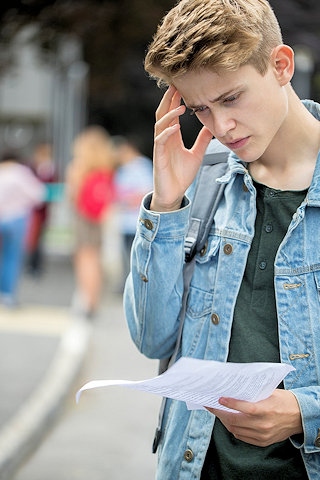 A teenage boy disappointed with his exam results