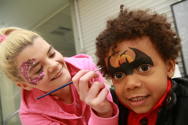 Luca Sodje has his face painted by Sarah McFarland of Little Unicorn Face Painting