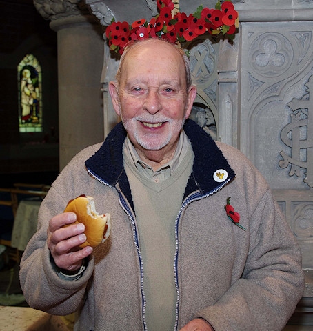 A man enjoys a burger at St Andrew's autumn fair 