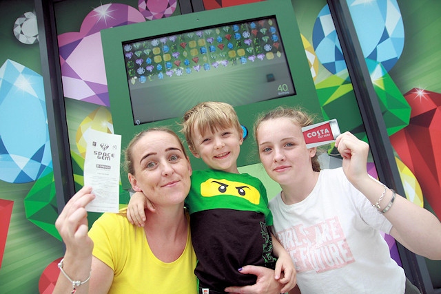 Charlotte Teasdale poses with son Oscar Teasdale (5) and daughter Tamara Cain (15) have a go at Rochdale Exchange’s life-size intergalactic, interactive game that was part of the centre’s 40th birthday celebrations