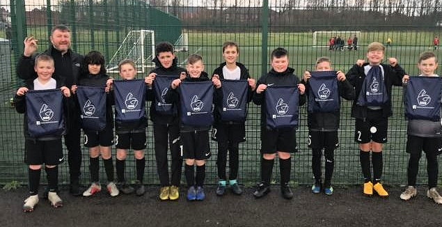 Shawclough U12s with their SG6 boot bags and water bottles from the foundation