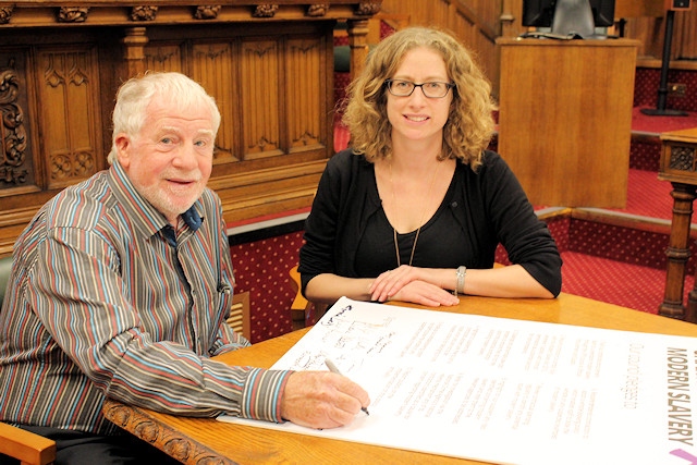 Councillor Allen Brett, leader of Rochdale Borough Council, signs the Charter Against Modern Slavery; with Claire McCarthy, General Secretary of the Co-operative Party