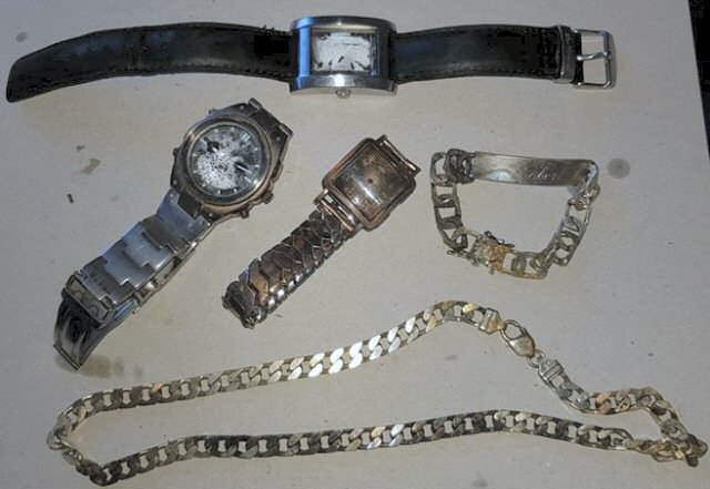 The items recovered from the canal, including the necklace engraved with 'Robert'
