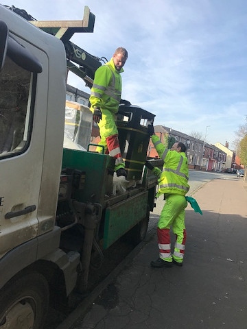 Council workers unload one of the new bins on Rooley Moor Road