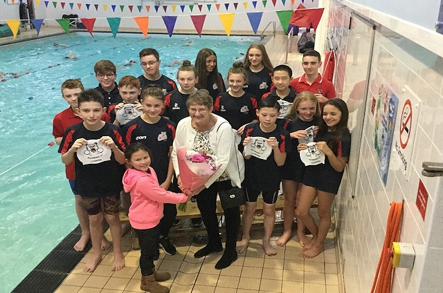 Aquabears receiving their swimming caps from Councillor Jean Hornby