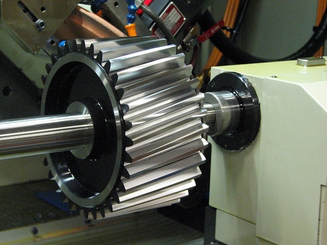 Precision grinding of a large face width pinion gear