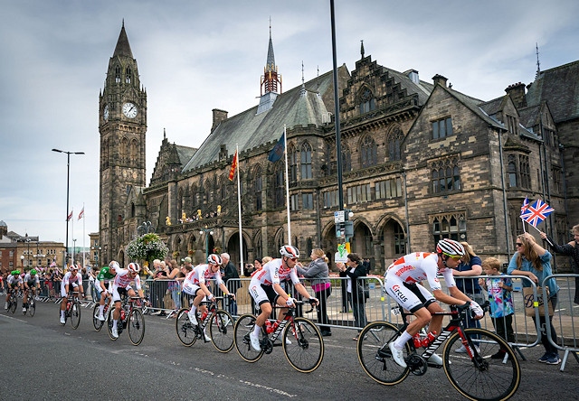 The riders pass along The Esplanade in front of Rochdale Town Hall