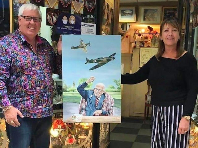 John Swinden and Lisa Haselden with her painting of Captain Tom Moore