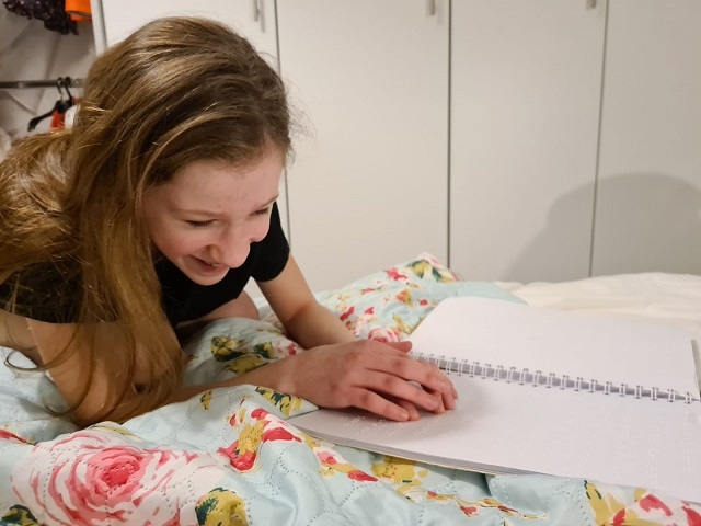 Elodie Bateson, 10, was born with vision impairment and is a big fan of RNIB Talking Books and also enjoys braille books
