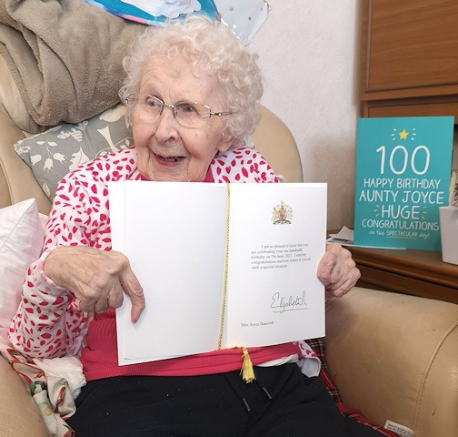 Joyce showing off her birthday card from the Queen