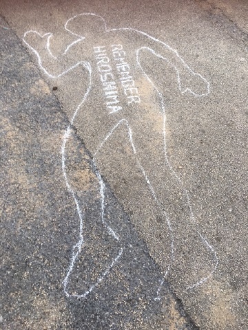 The blasts left behind imprints of people and objects in the path of radiation, leaving behind 'permanent shadows' - commemorated by the group with a white chalk outline of a person