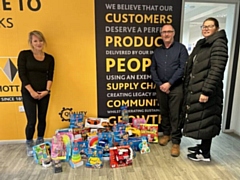Ameon’s Dave Scott, with some of the toy collection for kids, flanked by Willmott Dixon’s Sarah Cooper (left) and senior build manager on the Upperbanks development, Jaime Dawson