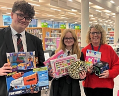 Helen Walton (right) from the Rochdale Giving Back Christmas Toy Appeal with Cardinal Langley School pupils Oliver and Lucy