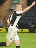 Gary Jones wheels away in celebration after scoring the winning penalty