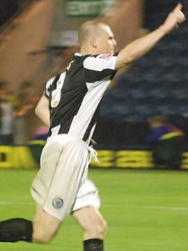 Gary Jones wheels away in celebration after scoring the winning penalty