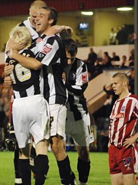 The Dale players celebrate with David Perkins after his goal sent the tie to extra time