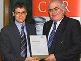 Chris Genasi (left) is pictured presenting Geoff Simpson with his fellowship at the CIPR's AGM in London.