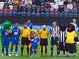 The captains and match officials line up for the pre-match photo