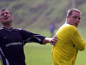 Rochdale Online's Danny Simpson competes for a header