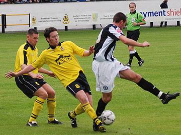 Southport's Liam Blakeman puts in a challenge on Rory McArdle