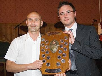 John Venables of Rochdale Nomads receives the Third Division trophy from Howard Ryder of Carcraft