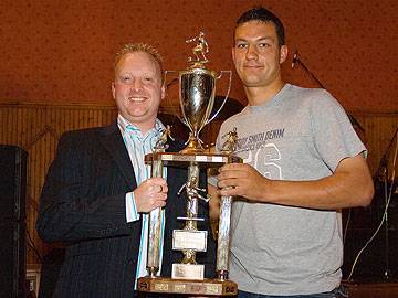 John Luker receives the Inter League trophy won by the R&DSFL open age team from Wayne Melvin of Carcraft