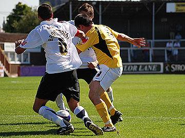 Chris Dagnall skips between two defenders before being tripped for Dale's penalty