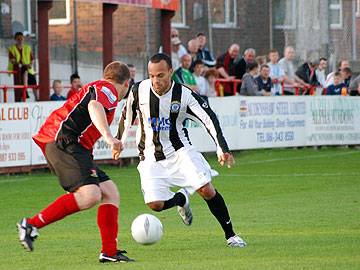 Jerome Watt looks to take on a Droylsden defender