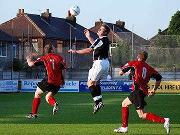 Dale assistant manager Dave Flitcroft wins a header in midfield